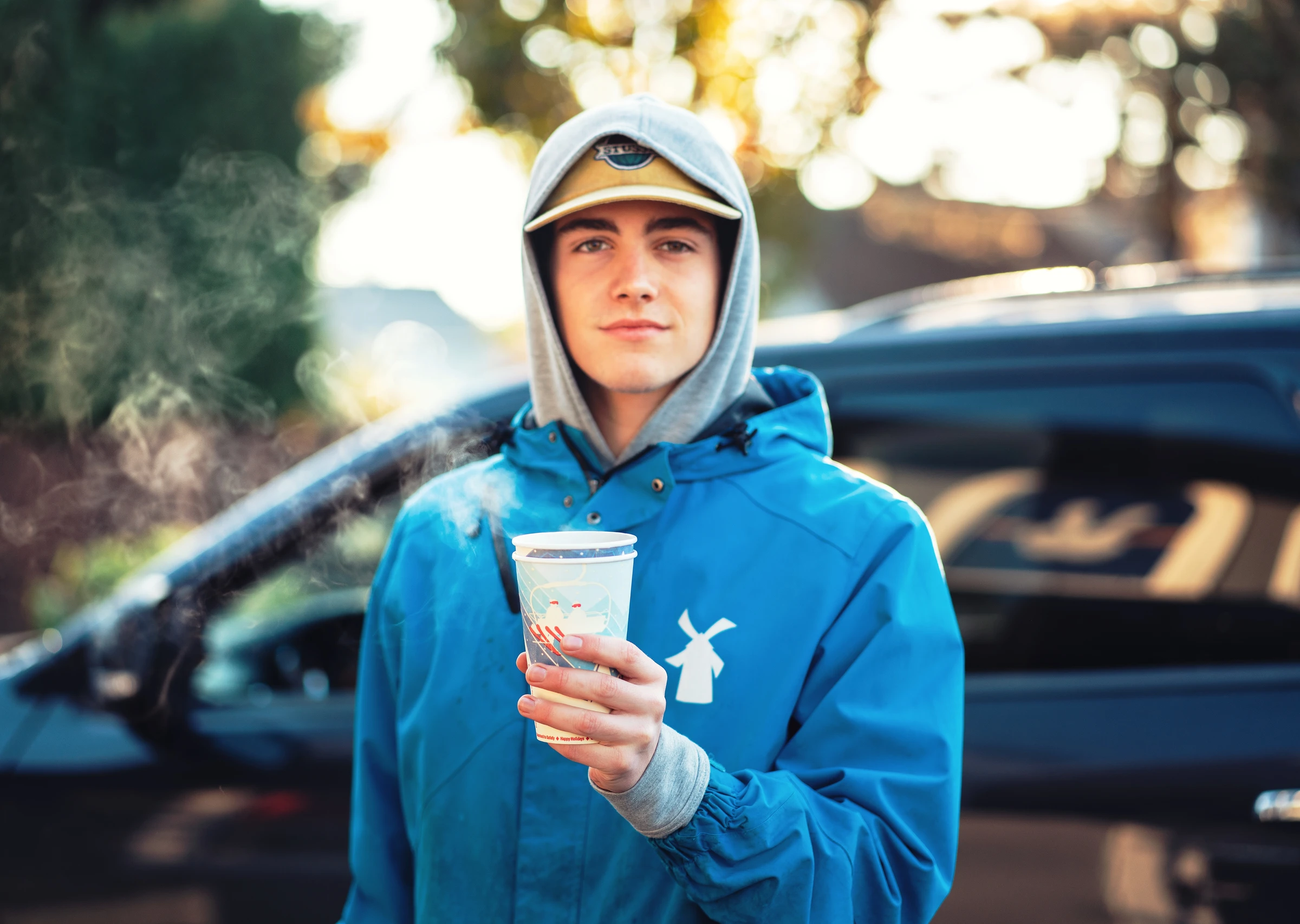 Tate holding an Americano